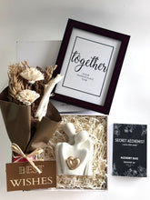 Load image into Gallery viewer, Luxury couple gift hamper by Grande Gift hampers featuring a ceramic figurine, dry flower bouquet, framed quote, and couple perfume set.